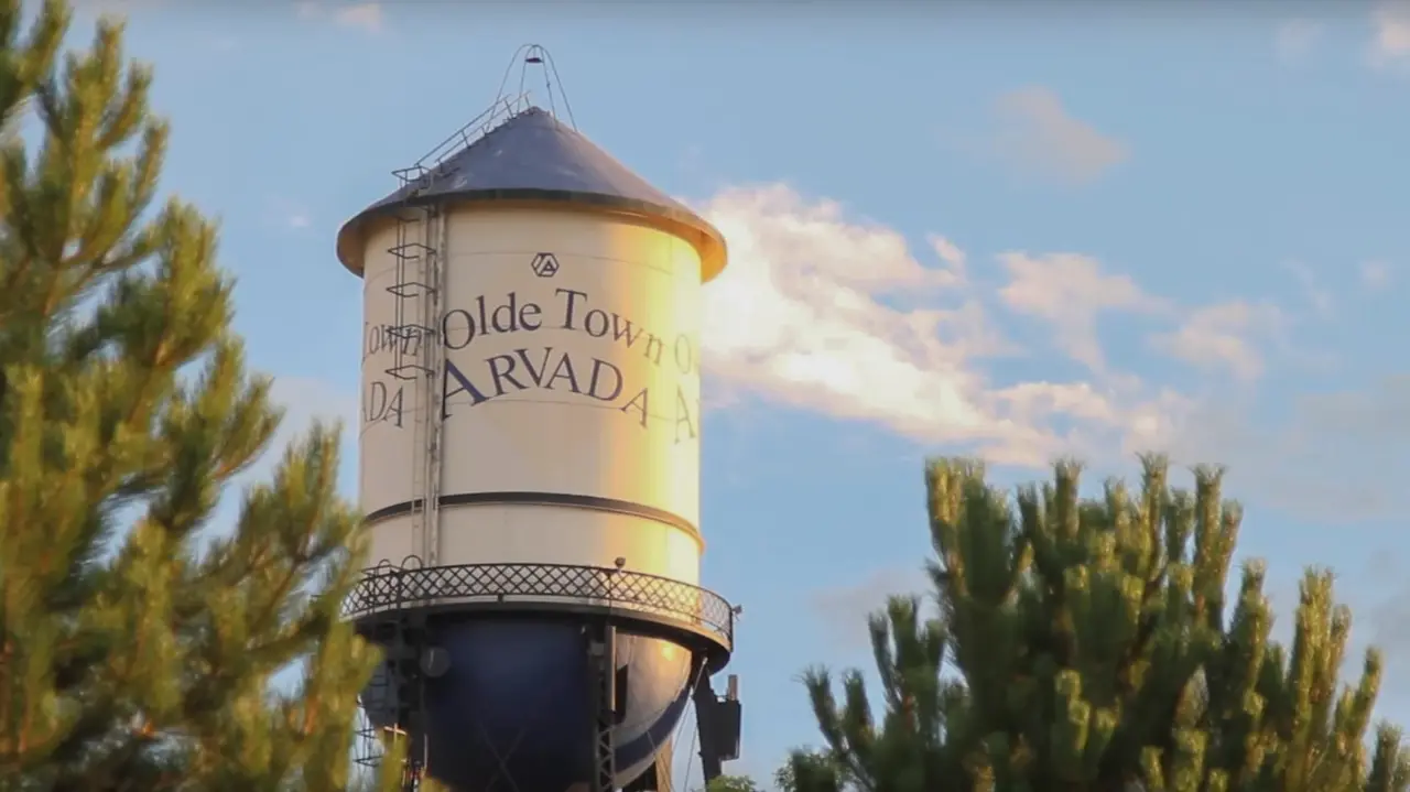 The Olde Town Arvada water tower against a blue sky