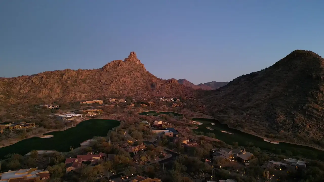 Pinnacle Peak glowing at sunset above desert golf course homes in north Scottsdale