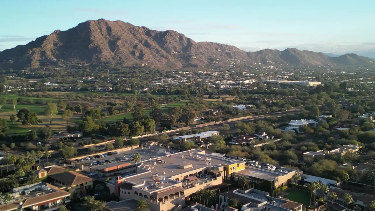 Camelback Mountain at golden hour above mid-rise buildings in central Scottsdale