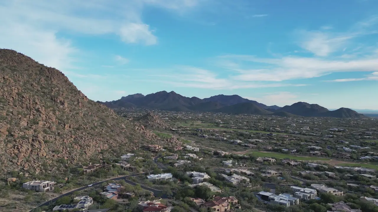 Desert hillside homes beneath a rocky ridge in the Paradise Valley area