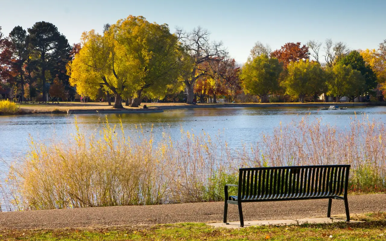Autumn cottonwoods reflected in a lake at Washington Park, Denver